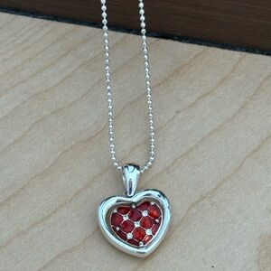 Avon heart necklace/ red on one side and clear stones on other/ silver tone
